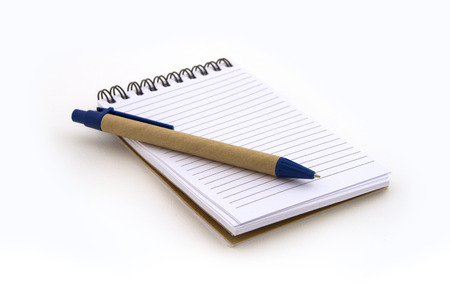 Note book with pen on white backgroundの写真素材