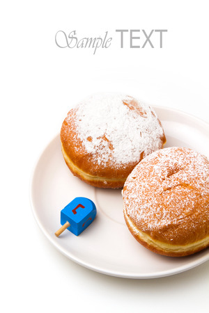 Donut with dreidel on plate. Hanukkah holiday.の写真素材