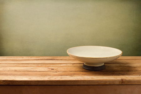 Retro background with plate on wooden table over grunge backgroundの写真素材