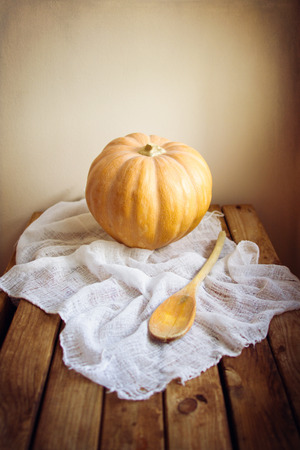 Pumpkin on wooden table with grunge textureの写真素材