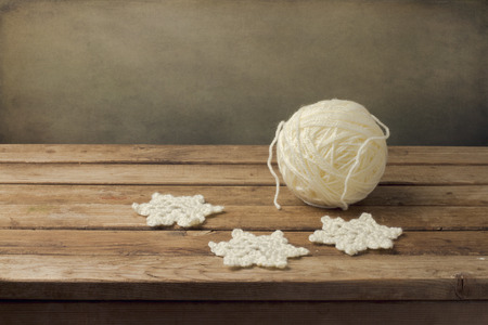 Crochet christmas snowflakes on wooden tableの写真素材