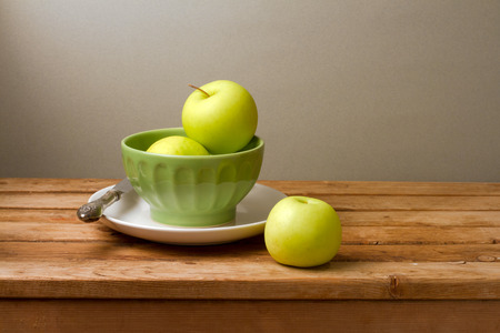 Fresh green apples on wooden tableの写真素材