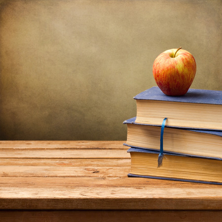 Background with vintage books and apple.の写真素材
