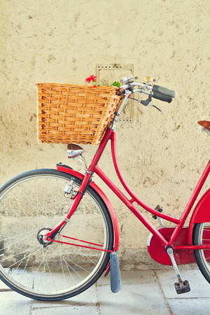 Vintage bicycle with basket over concrete wallの写真素材