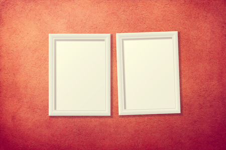 Blank picture frames on red grunge wallの写真素材
