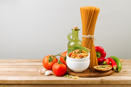 Italian pasta and vegetables on wooden tableの写真素材