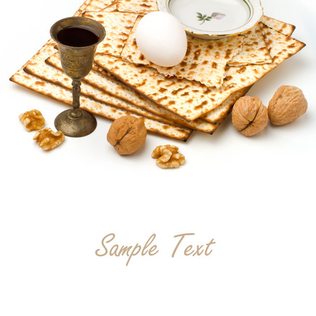 Matzo, egg, walnuts and wine for passover celebration on white background