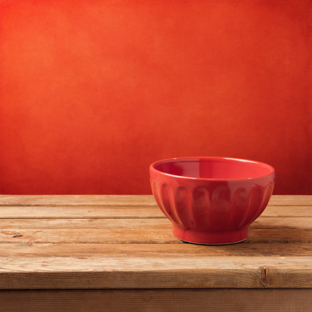 Empty red bowl over grunge backgroundの写真素材