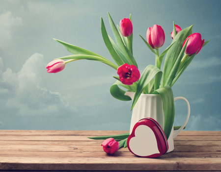 Valentine's Day concept. Beautiful tulip bouquet with heart shape boxの写真素材