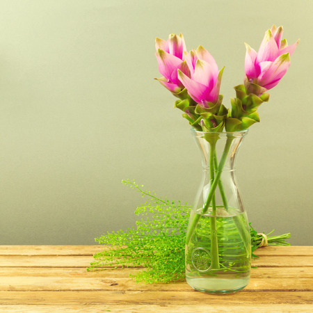 Beautiful pink flower bouquet on wooden tableの写真素材