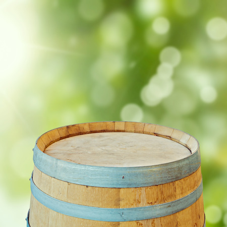 Wooden barrel over garden bokeh backgroundの写真素材