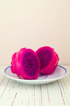 Dragon fruit pitaya on plate on white tableの写真素材