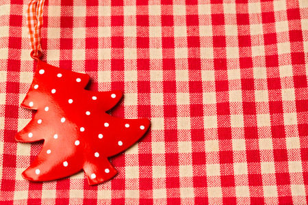 Christmas tree ornament on red checked tableclothの写真素材