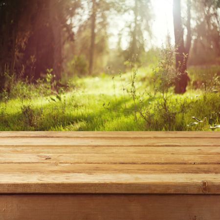 Empty wooden deck table over forest backgroundの写真素材