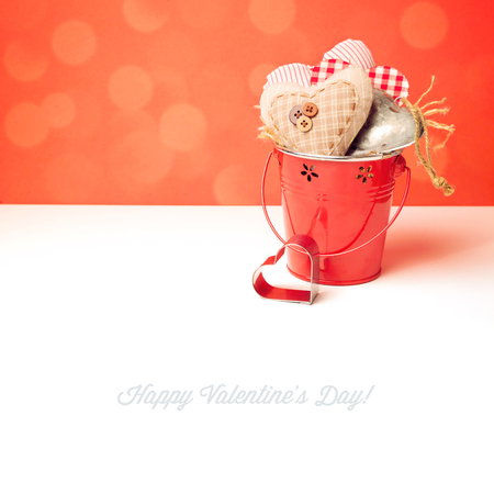 Valentine's day heart shapes in bucket on white tableの写真素材