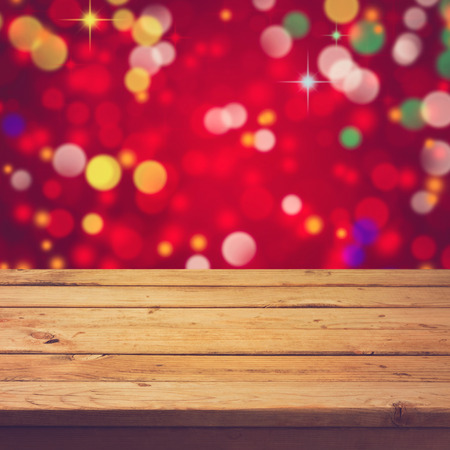 Empty wooden deck table over festive bokeh backgroundの写真素材