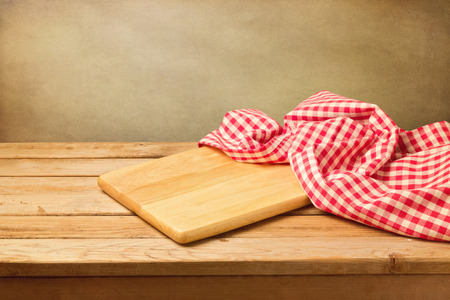 Cutting board and tablecloth on wooden tableの写真素材
