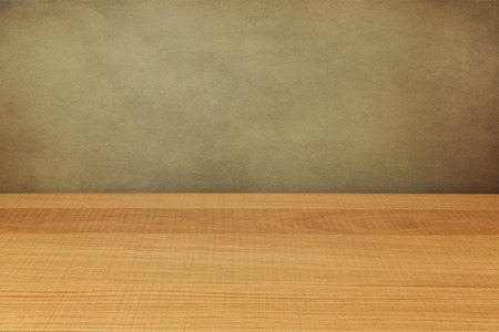 Empty wooden counter over grunge wallの写真素材