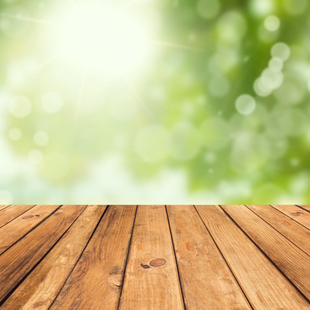Vintage wooden planks over bokeh green backgroundの写真素材