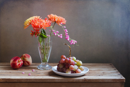 Flowers and fruits on wooden vintage tableの写真素材