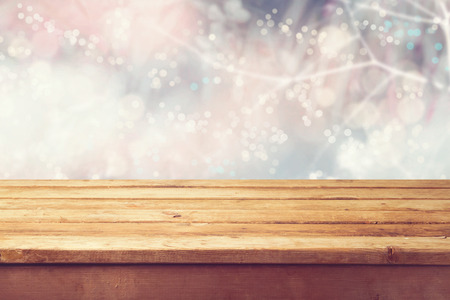 Christmas holiday with empty wooden deck table over winter bokeh. Ready for product montageの写真素材