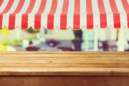 Wooden table counter with awing for product montage display