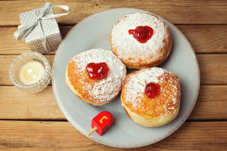 Donuts with jam for Jewish Holiday Hanukkah over wooden backgroundの写真素材