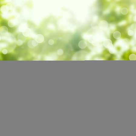 Empty wooden white table over green bokeh backgroundの写真素材