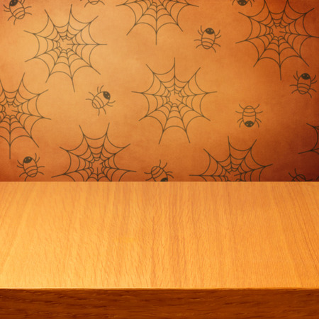 Halloween holiday background with empty wooden table and wallpaper with spidersの写真素材