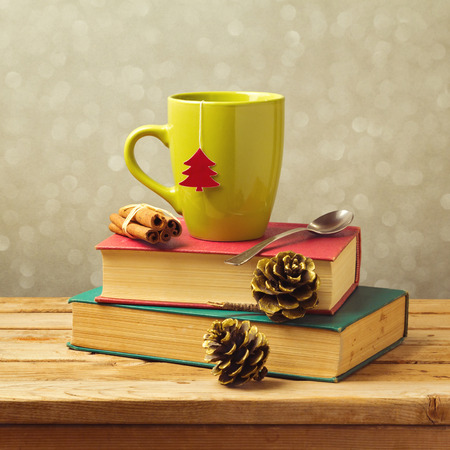 Christmas tea mug on books with decorationsの写真素材