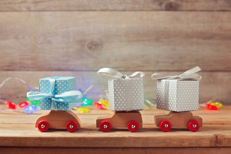 Christmas holiday concept with gift boxes on toy carsの写真素材