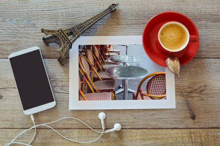 Photo of restaurant in Paris on wooden table with coffee cup and smart phone. View from aboveの写真素材