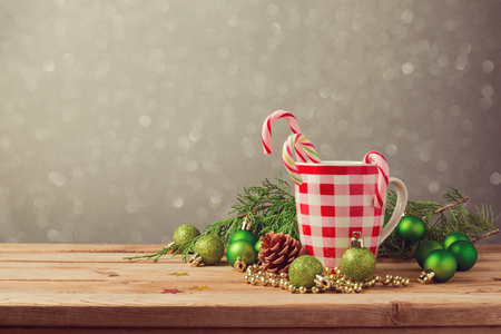 Christmas holiday decorations with checked cup and candy on wooden tableの写真素材