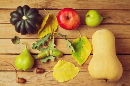 Autumn pumpkin and fruits on wooden tableの写真素材