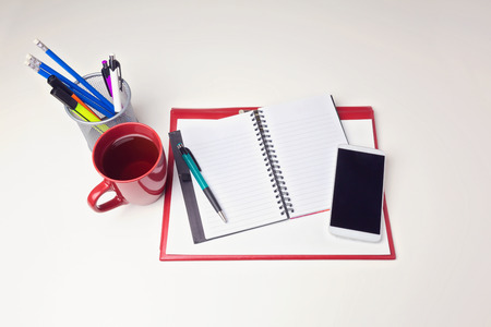 Office desk table with mobile phone and coffee cupの写真素材