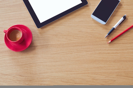 Tablet with blank screen on wooden table. Office desk mock up. View from aboveの写真素材