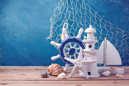 Marine lifestyle decorations on wooden table over blue grunge backgroundの写真素材