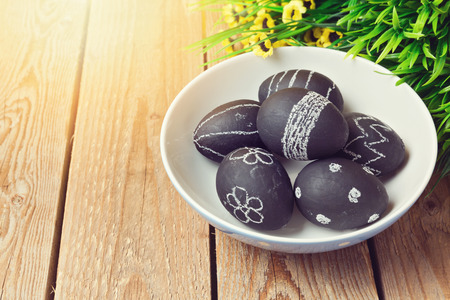 Easter eggs painted with chalkboard paint on wooden backgroundの写真素材