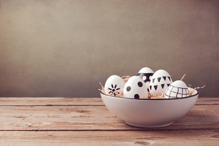 Easter eggs with hand drawing ornament on wooden tableの写真素材