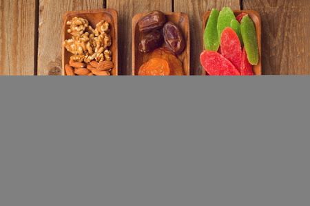 Assorted dry fruits and nuts on wooden table. View from aboveの写真素材