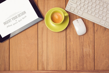 Office desk mock up template with tablet, keyboard and coffee cup. View from aboveの写真素材