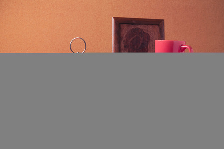 Coffee cup on stack of books on wooden table