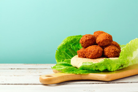 Falafel balls served with pita on a wooden boardの写真素材