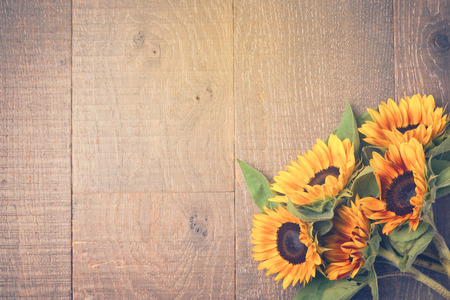 Autumn background with sunflowers on wooden table. View from above. Retro filter effectの写真素材