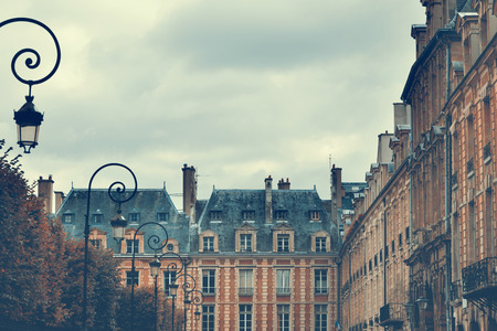 Place des Vosges in Paris, France in autumn. Retro filter effectの写真素材