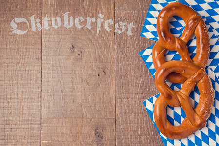 Oktoberfest german beer festival  background with pretzel on wooden tableの写真素材