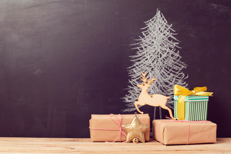 Christmas gift boxes under tree drawing on chalkboard. Alternative Christmas tree backgroundの写真素材