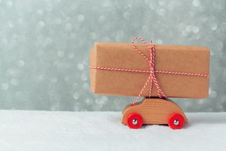 Gift box on toy car. Christmas holiday celebration conceptの写真素材