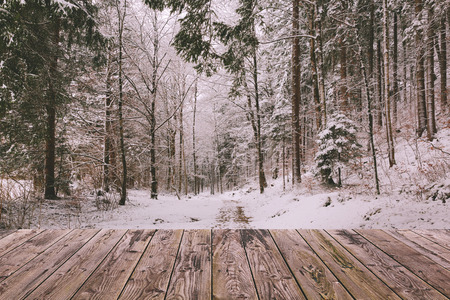 Winter background with wooden terrace and nature forest landscape. Christmas holiday conceptの写真素材