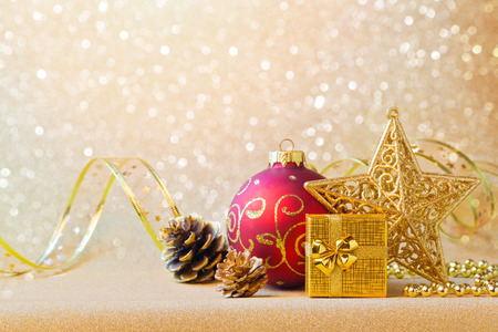 Christmas decorations in red and gold over glitter sparkle backgroundの写真素材